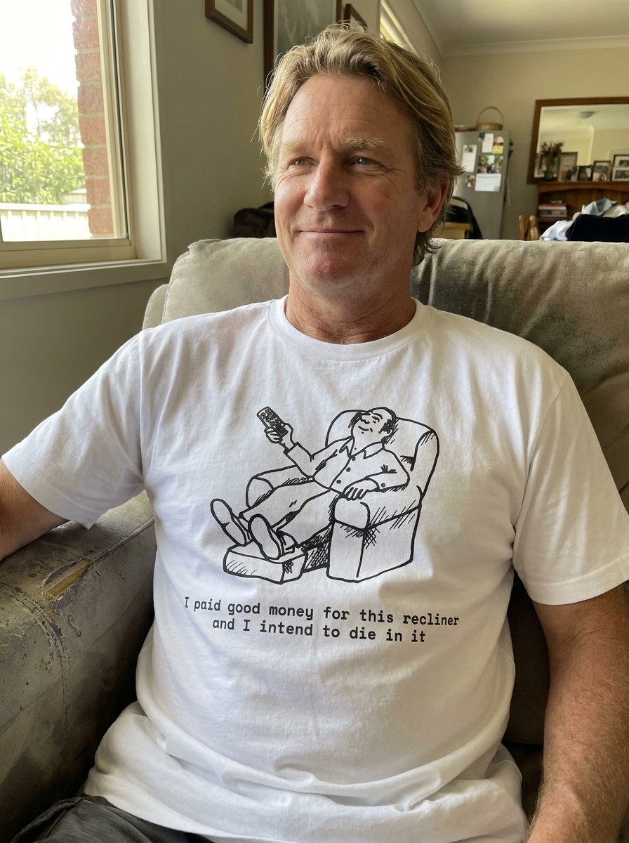 A dad wearing The Recliner Throne tee at home